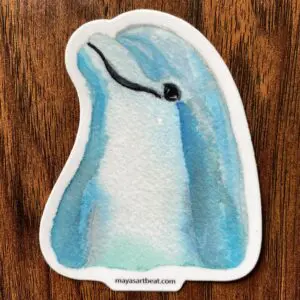 Watercolor dolphin sticker on wooden surface