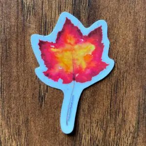Maple leaf sticker on wooden surface