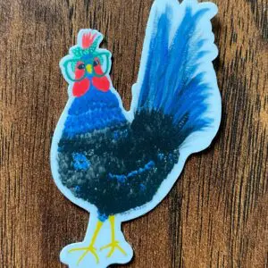 Colorful rooster sticker on wooden surface