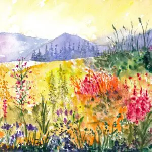 Colorful field with wildflowers and mountains.