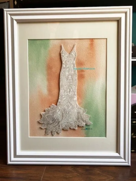 Framed artwork of a lace wedding dress