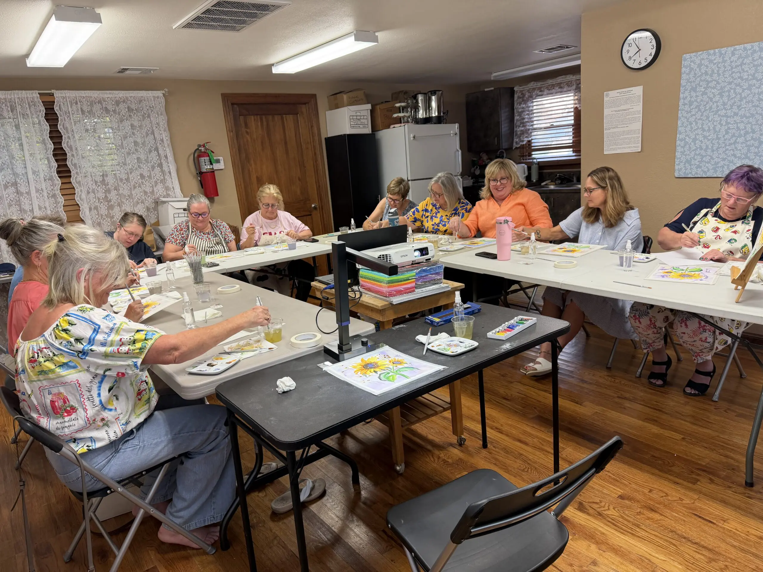 Women painting together in community art class