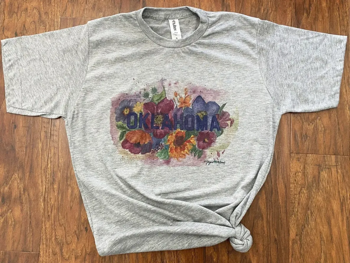 T-shirt featuring Oklahoma and vibrant flowers.