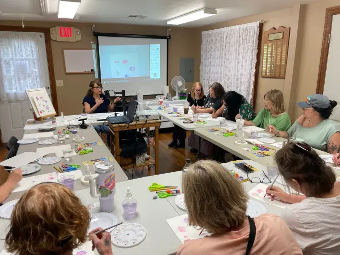Adults painting in group art workshop